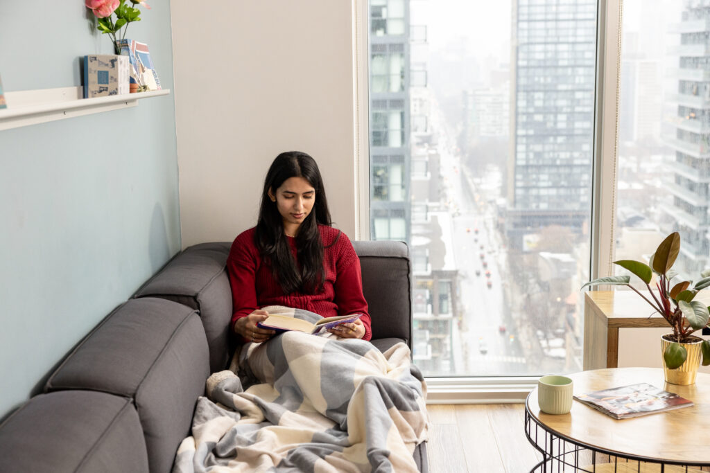 Student reading on sofa.