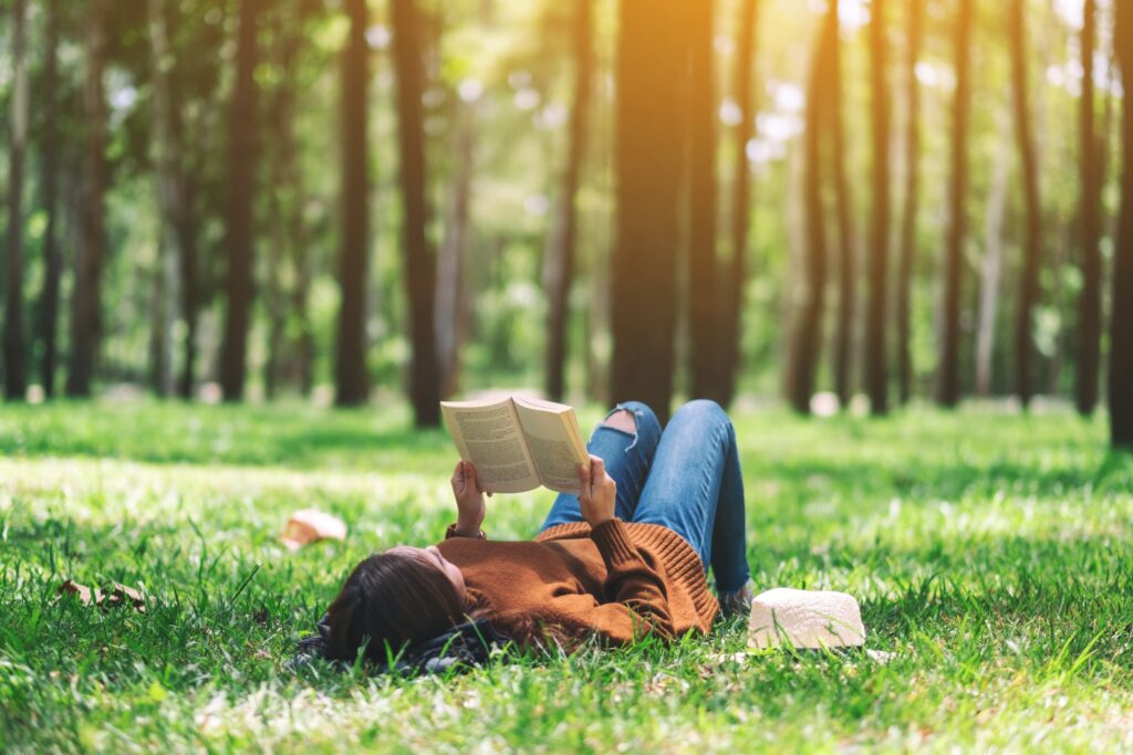 Student reading on grass.